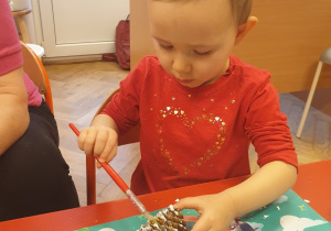Dziewczynka wykonuje pracę plastyczną