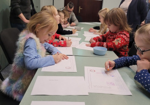 dzieci rysuja list do Swiętego Mikołaja